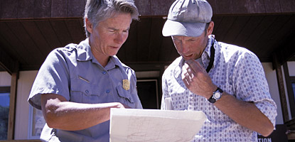Studying maps at the Hans Flat Ranger Station, gateway to the Maze District