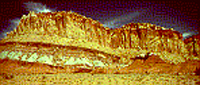 Geologic layering is depicted the different colored layers of this butte