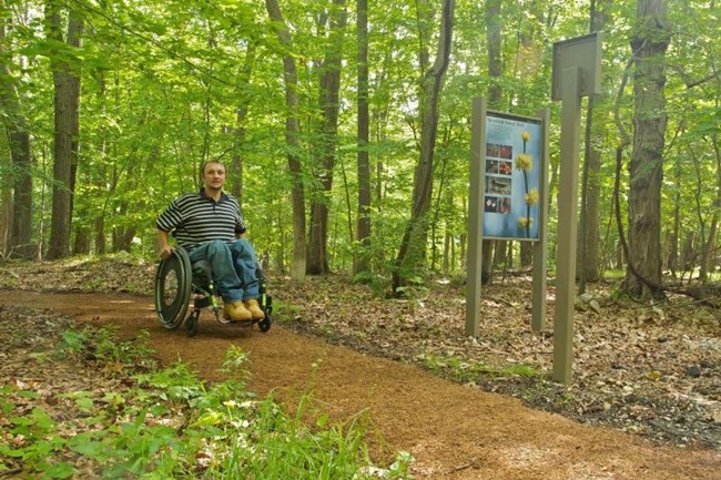 Visitor in wheelchair on Spicebush Trail