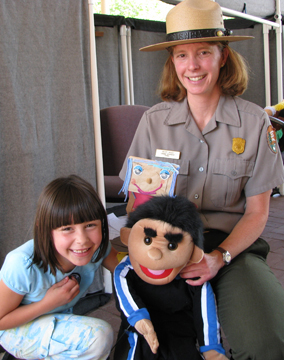Junior Ranger with Park Ranger and puppets