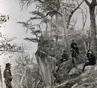 General Grant stands on Lookout Mountain with other soldiers.