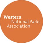 Brown circular WNPA Logo with white lettering