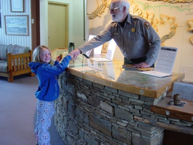 Photo of Prairie Bergman getting her Junior Ranger badge.