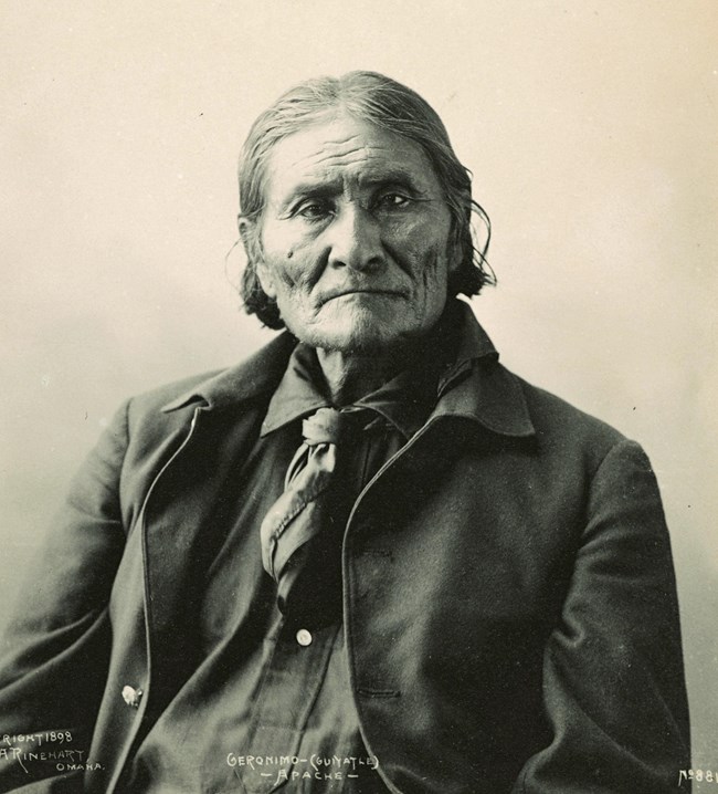 Sepia-toned portrait of older man wearing a jacket.