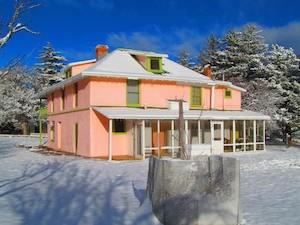 A colorful ranch house dusted in snow