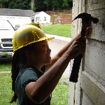 Photo park volunteer repairing building.