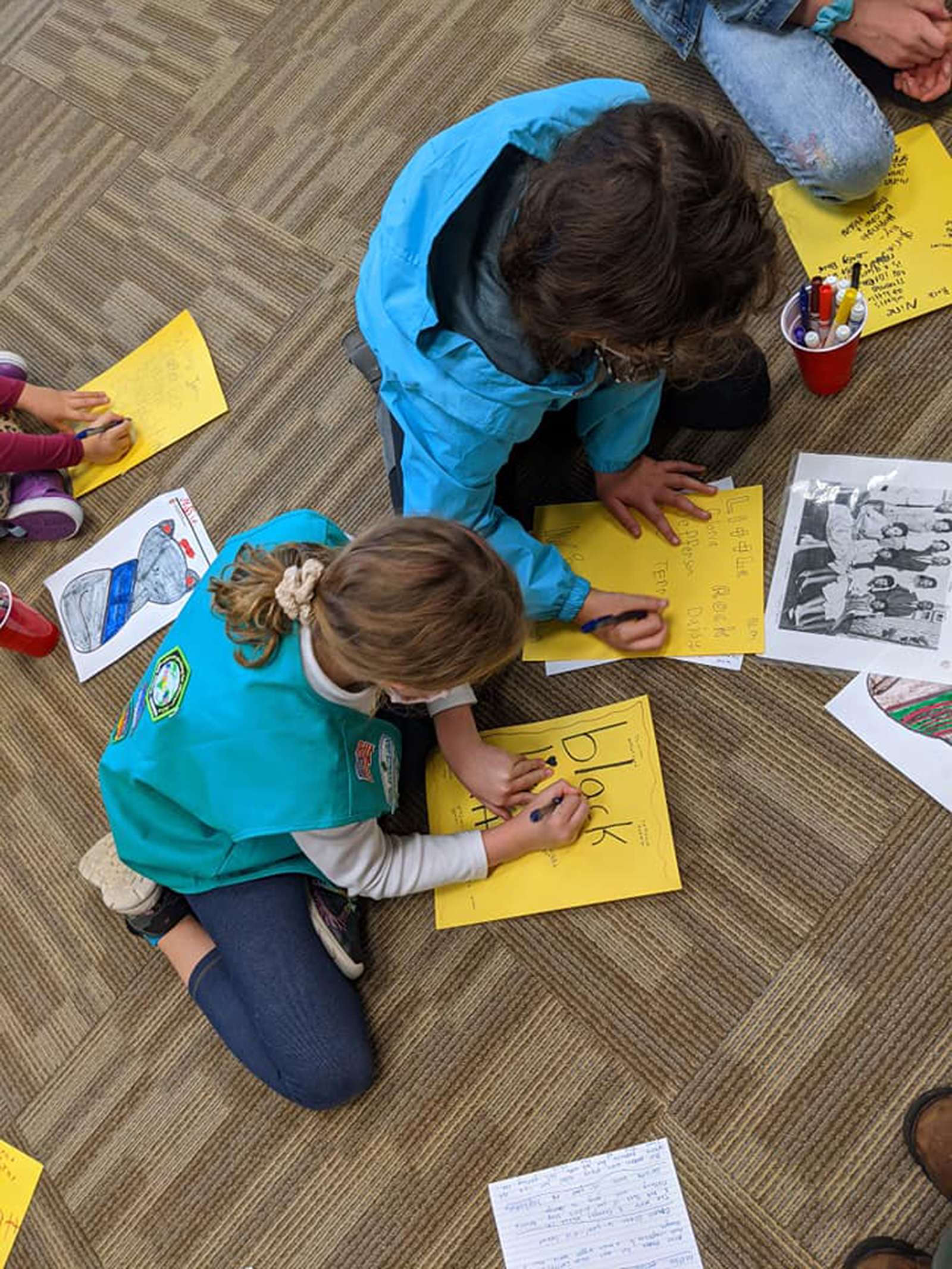 Girl Scouts work on an activity about the Little Rock Nine and the story of Little Rock Central High School