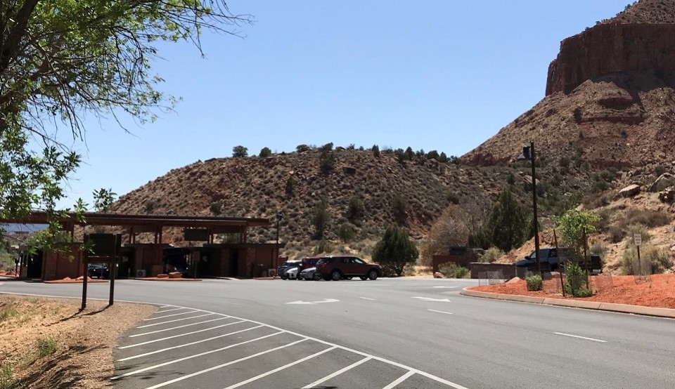 Black and white photo of the South Entrance with a road and structure and cliffs in the background.