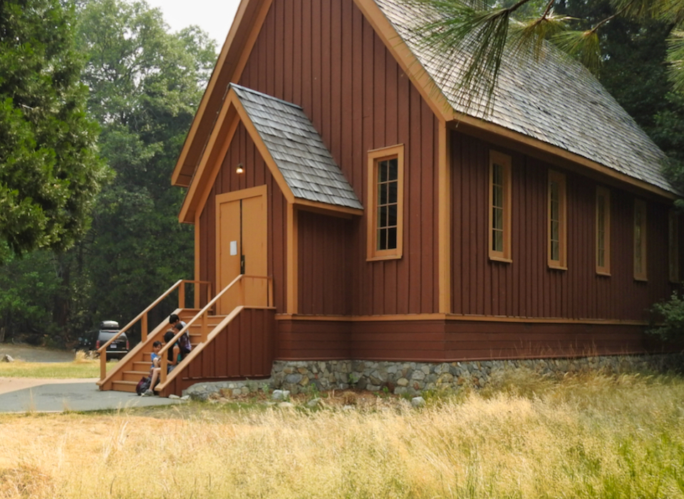 Horses and buggy in front of chapel