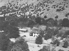 Aerial view of Faraway Ranch buildings at the base of a steep hillside