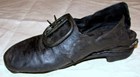 archival photo, black leather shoe with metal buckle