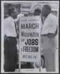 Two men holding sign. 