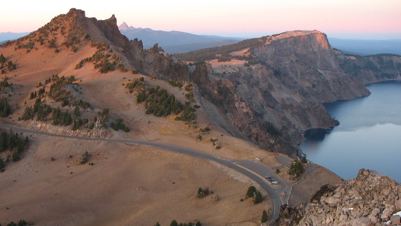 View of Rim Drive from Watchman Peak.  Hillman Peak and Crater Lake in the background.