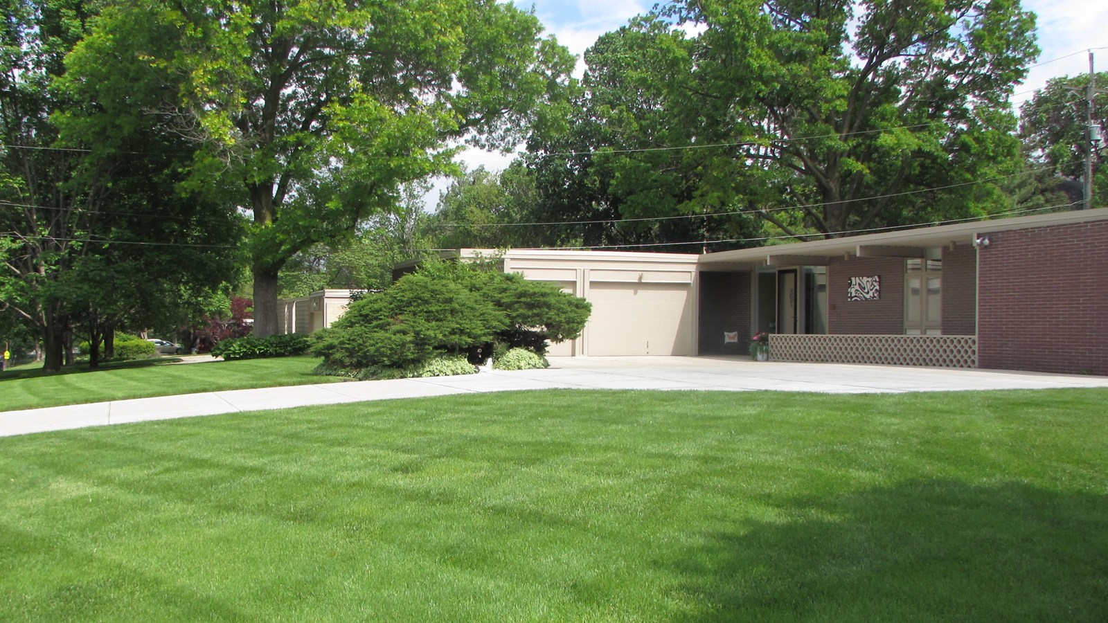 Mid-century homes, one story with attached garages, flat roofs, and breeze-block walls.