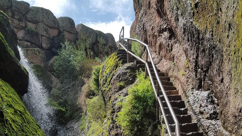 Narrow rock staircase edged out of rock wall  in a narrow rock canyon