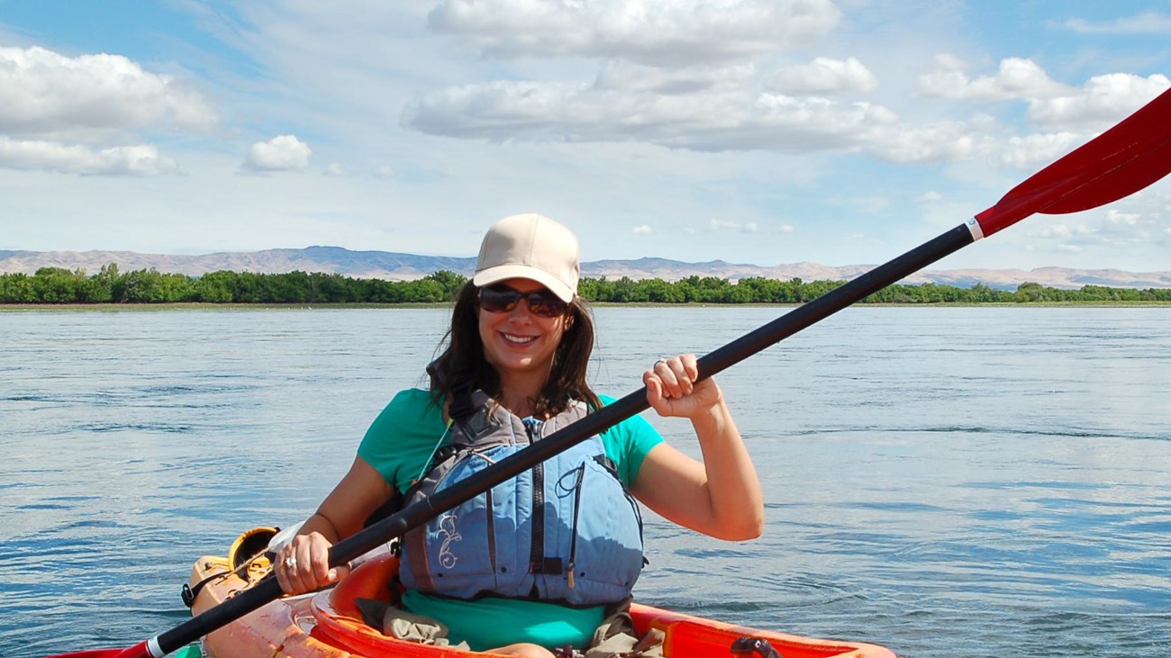 Color photograph of a kayaker on a major river