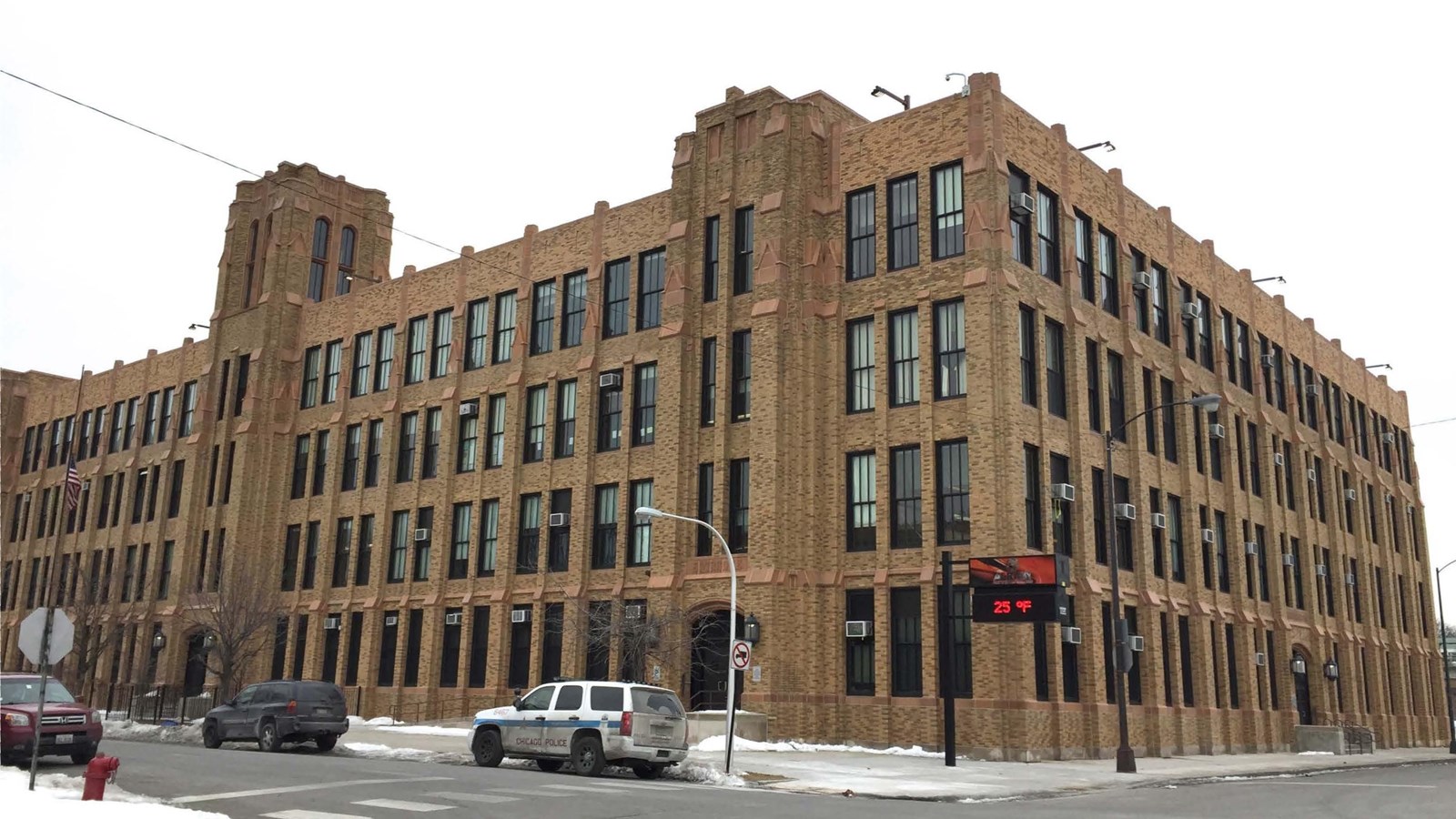 Monumental 4-story brick school building, taking up a city block, designed in Gothic Revival style