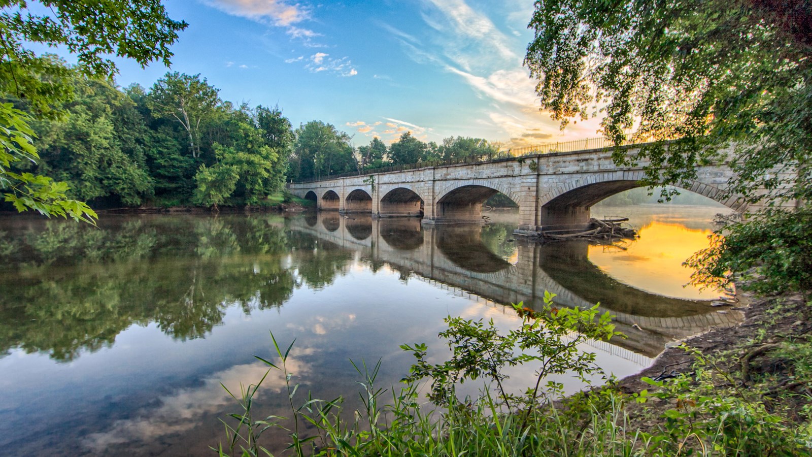A blue and orange sky over the aqueduct.