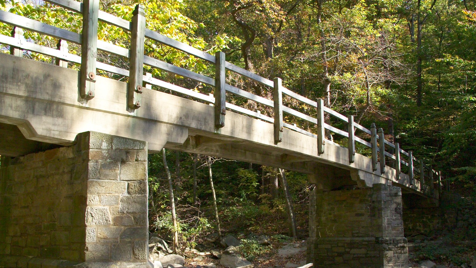 A concrete bridge span with cut stone footings