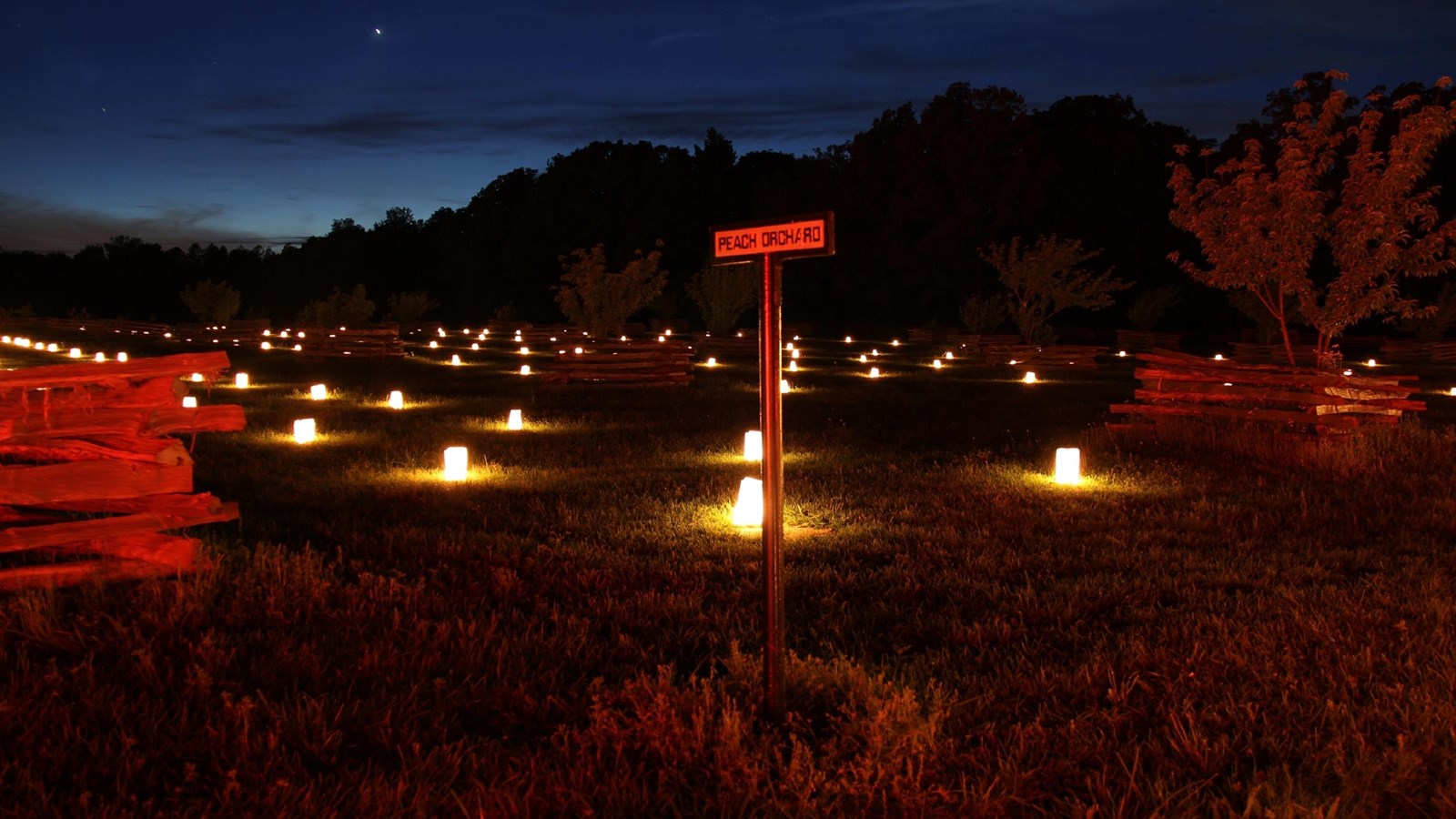 Luminaries light the Peach Orchard