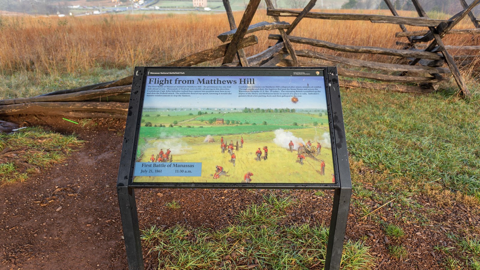 An informational panel in front of a field. 