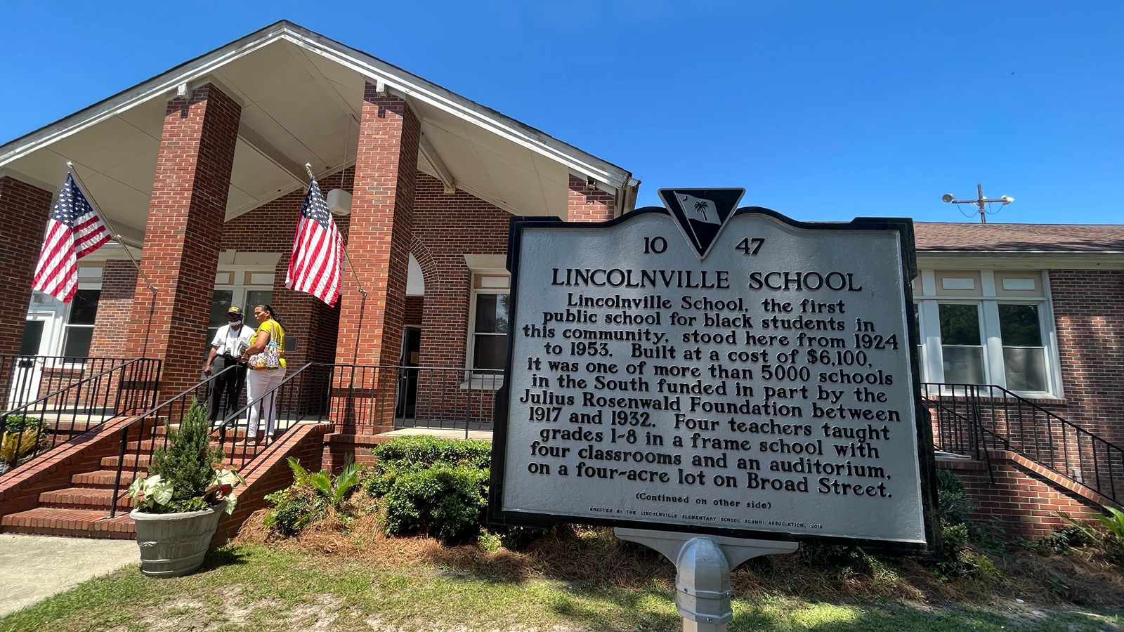 A white sign with black text reads 