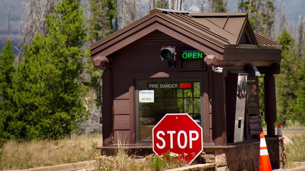 a ranger booth with mountains in the background