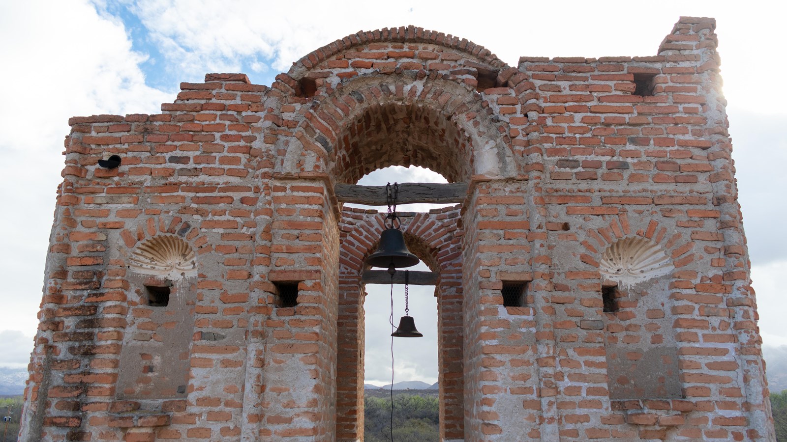 Brick bell tower with one corner unfinished