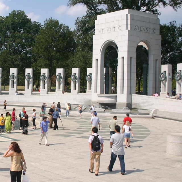 Visitors explore the World War II Memorial on the National Mall in Washington, D.C.
