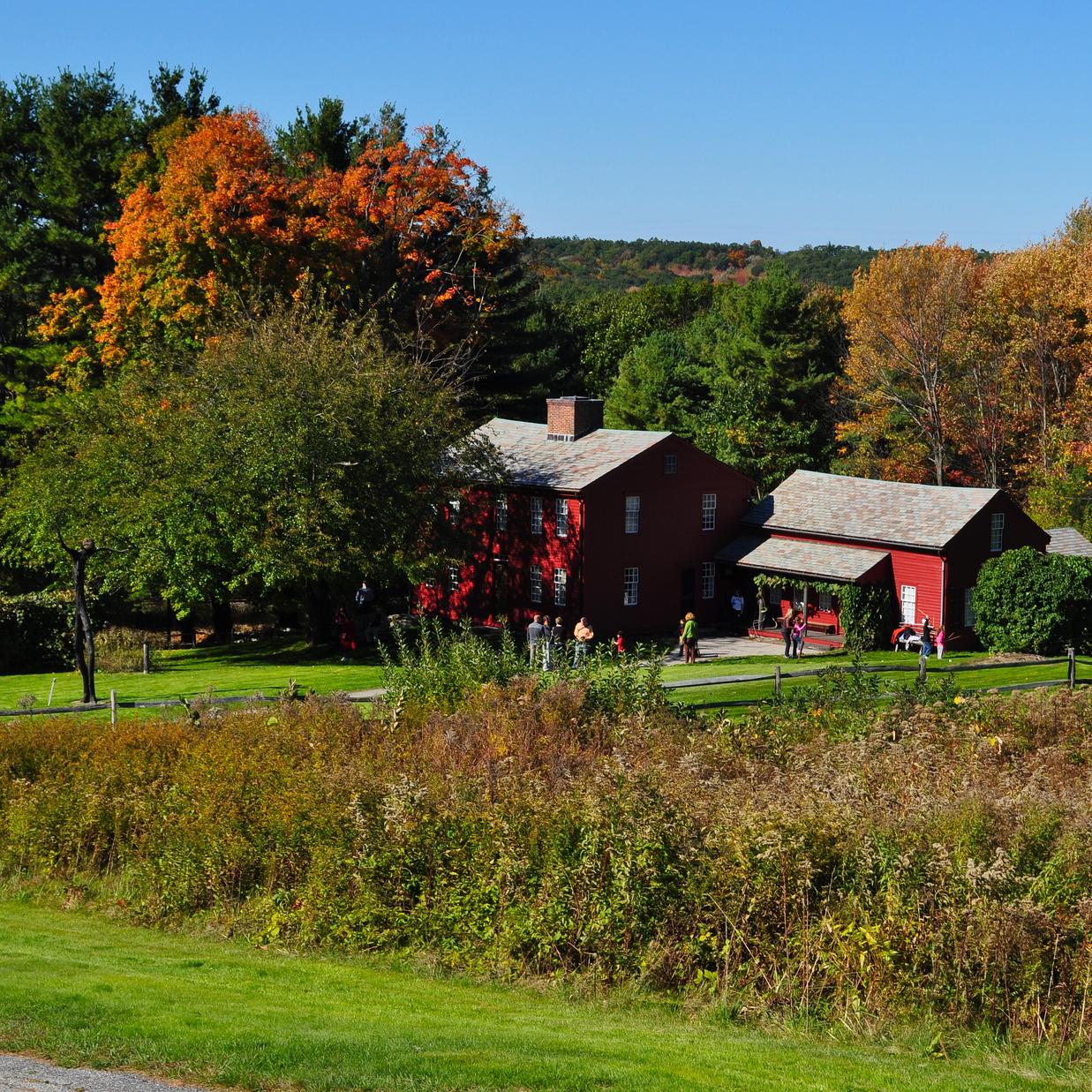 red clapboard buildings in a rural setting