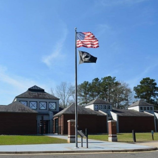 Brick building with flags flying in front