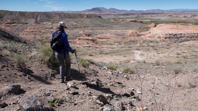 A person hikes on a trail.