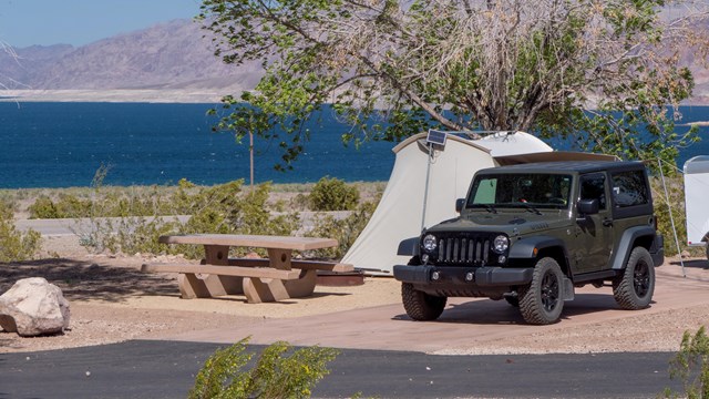 a car next to a tent