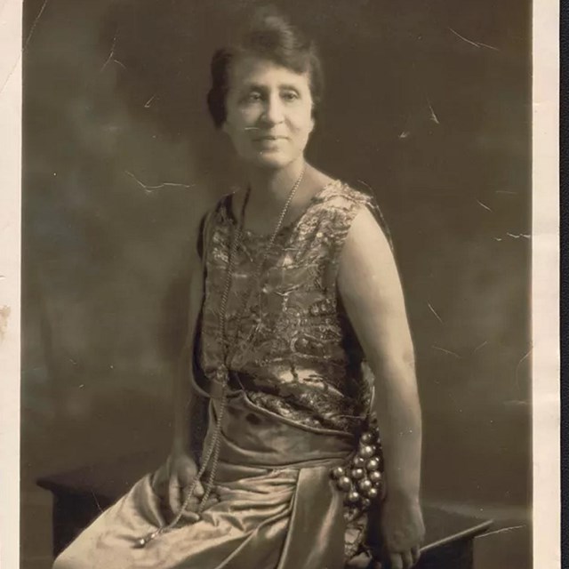 sepia toned image of a woman in 1920s dress