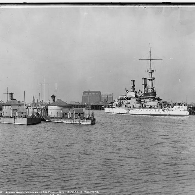 Grey scale photograph of ships in a ship yard