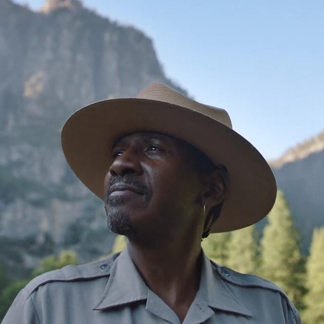 Park Ranger with Mountains in the Background