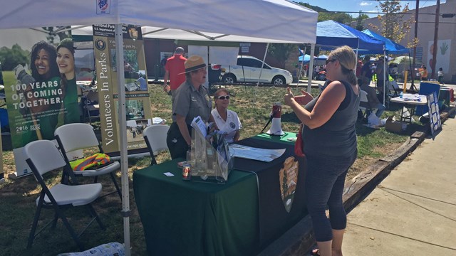 Park ranger greets visitors at a public event