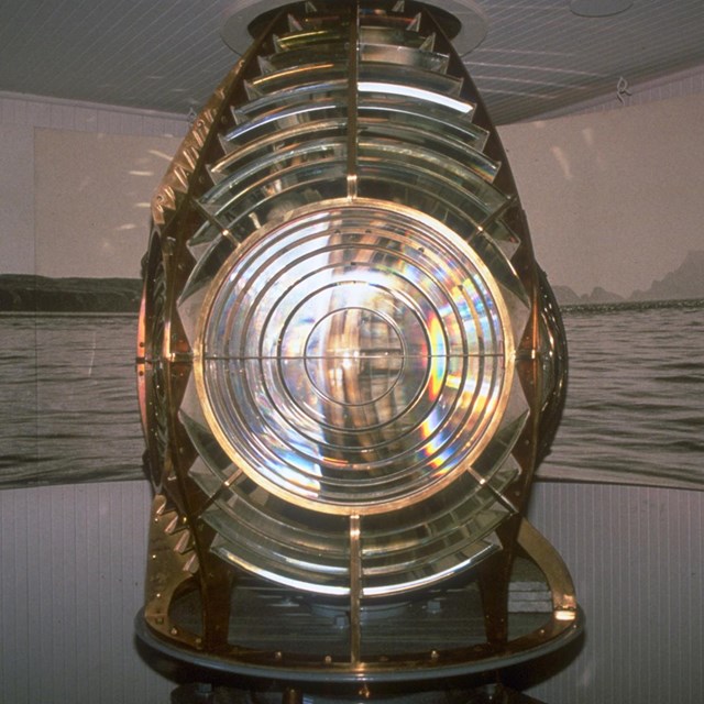 Closeup of glass and brass of fresnel lense.
