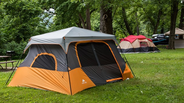 Orange and gray tent in a campground