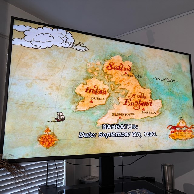 The screen of a tv with a video playing with captions on.