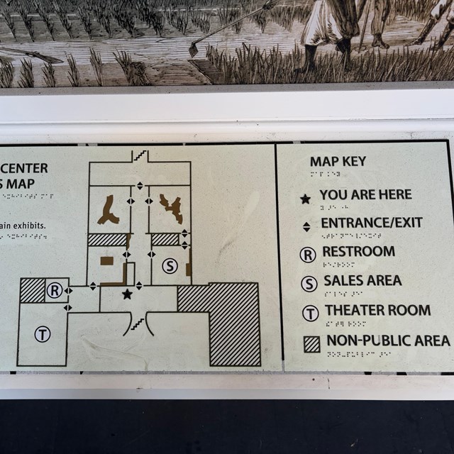 Tactile map with the floor plan of a house with exhibits, a restroom, and theater marked.