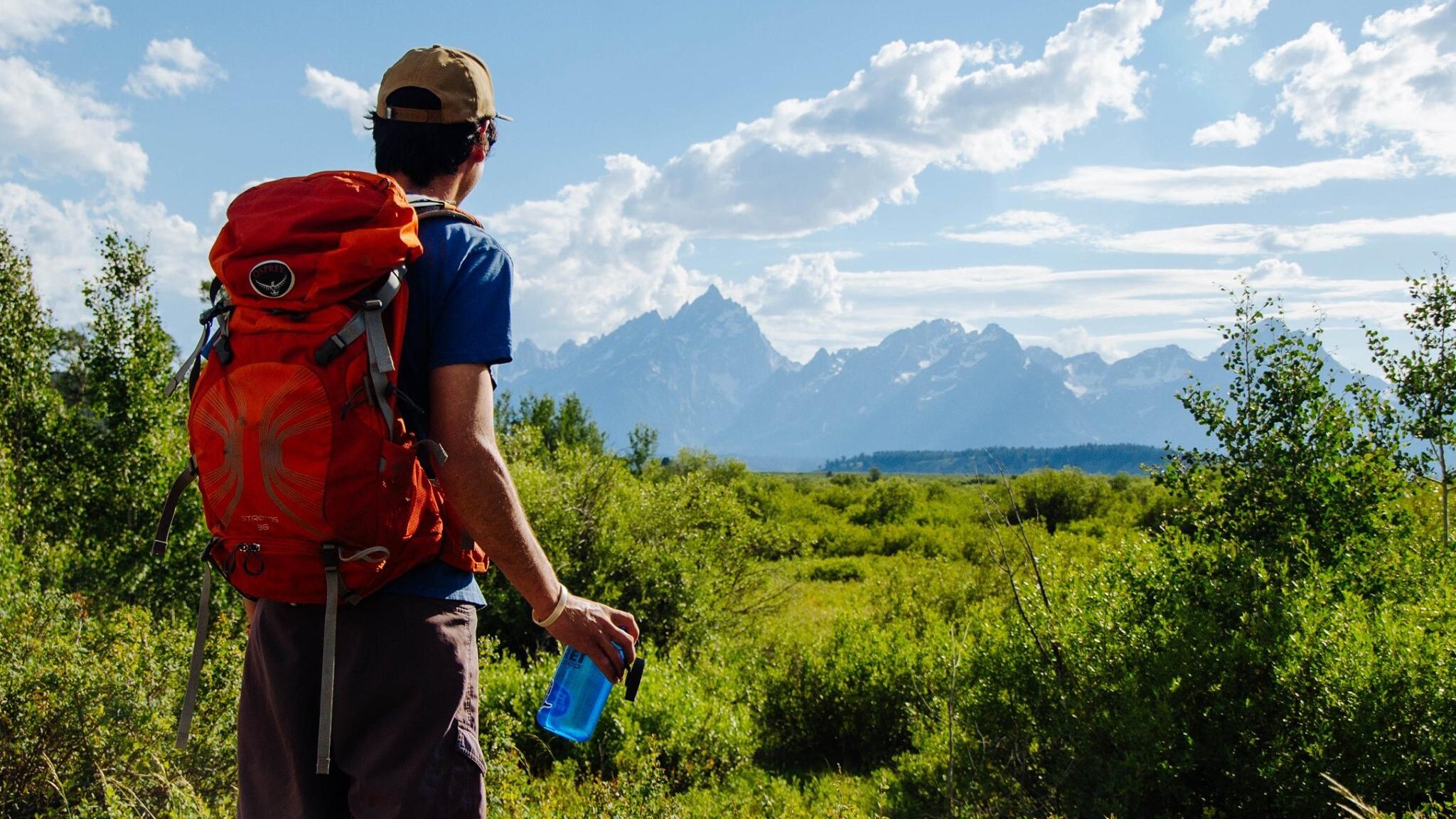 Hiker with backpack and water bottle