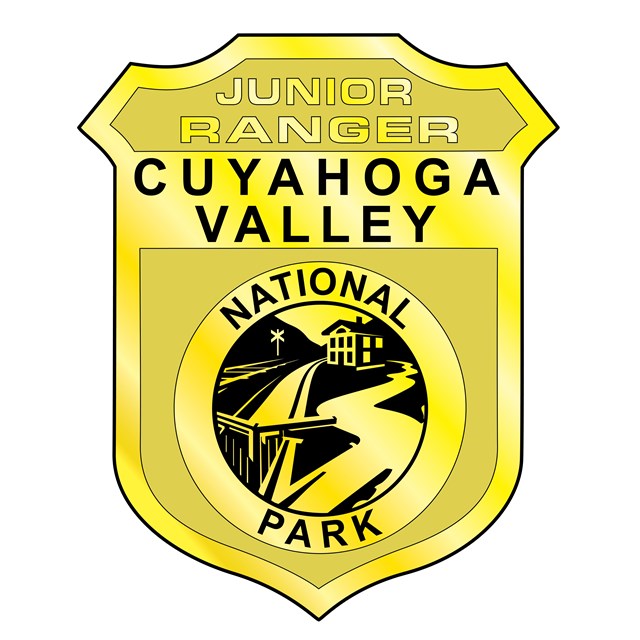 An illustration of the Cuyahoga Valley National Park Junior Ranger badge in the shape of a shield