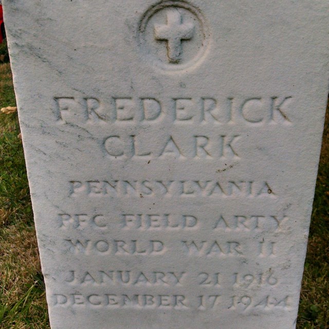 A white marble headstone with the name Frederick Clark