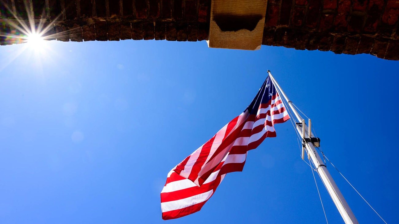 A picture of the flag at Fort McHenry from the perspective of looking up from the sally port.