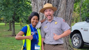 Volunteer and ranger giving the thumbs up sign