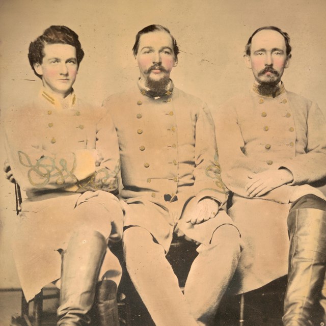 Three Confederate soldiers posing for photograph