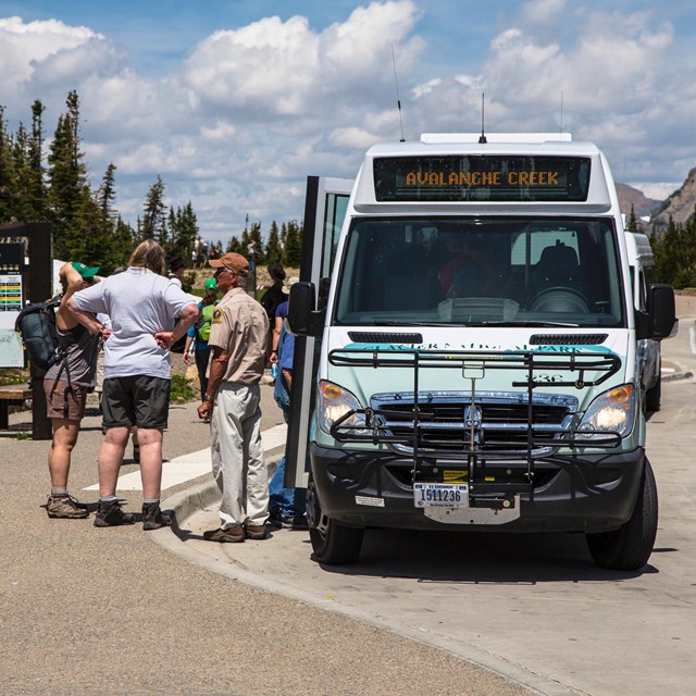 Free shuttle at Logan Pass shuttle stop with visitors