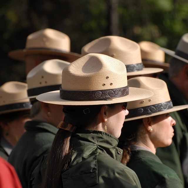 A group of people in flat hats