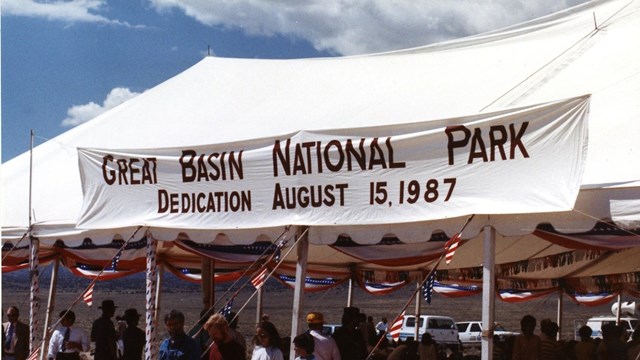 A large canopy tent & banner with text "Great Basin National Park Dedication August 15, 1987"